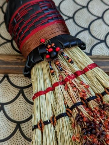 detail of broomcorn seeds, stitching, beading, leather plaiting