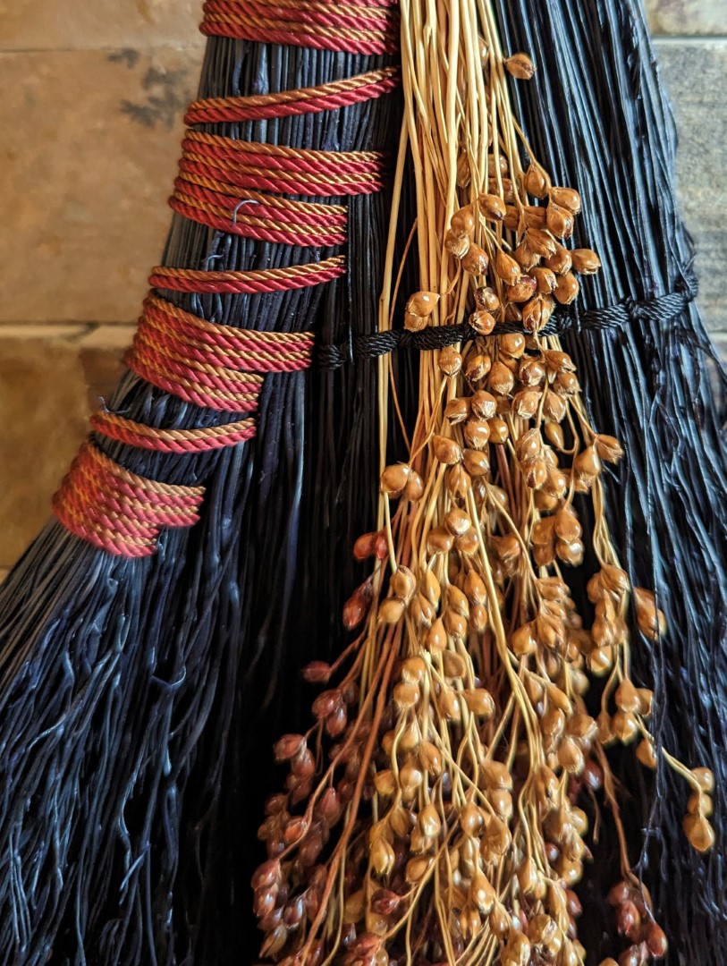 Brick Red and Terra Cotta colored cording. There are dark red and brown broomcorn seeds woven in. 