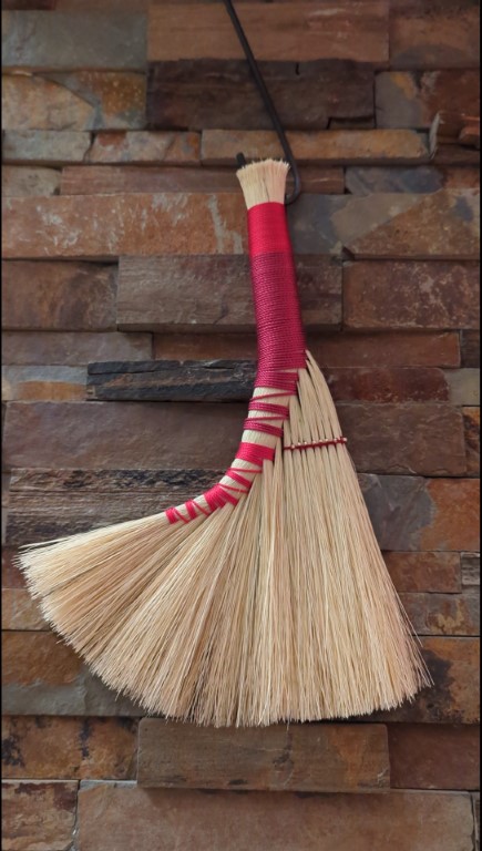 Overview shot of Large Tampico Hand Broom - Red and Magenta with Beading on brick background