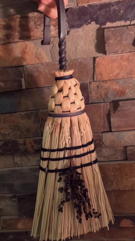 Short hearth broom with vintage metal hook, natural broomcorn fibers, three rows of stitching and seed details